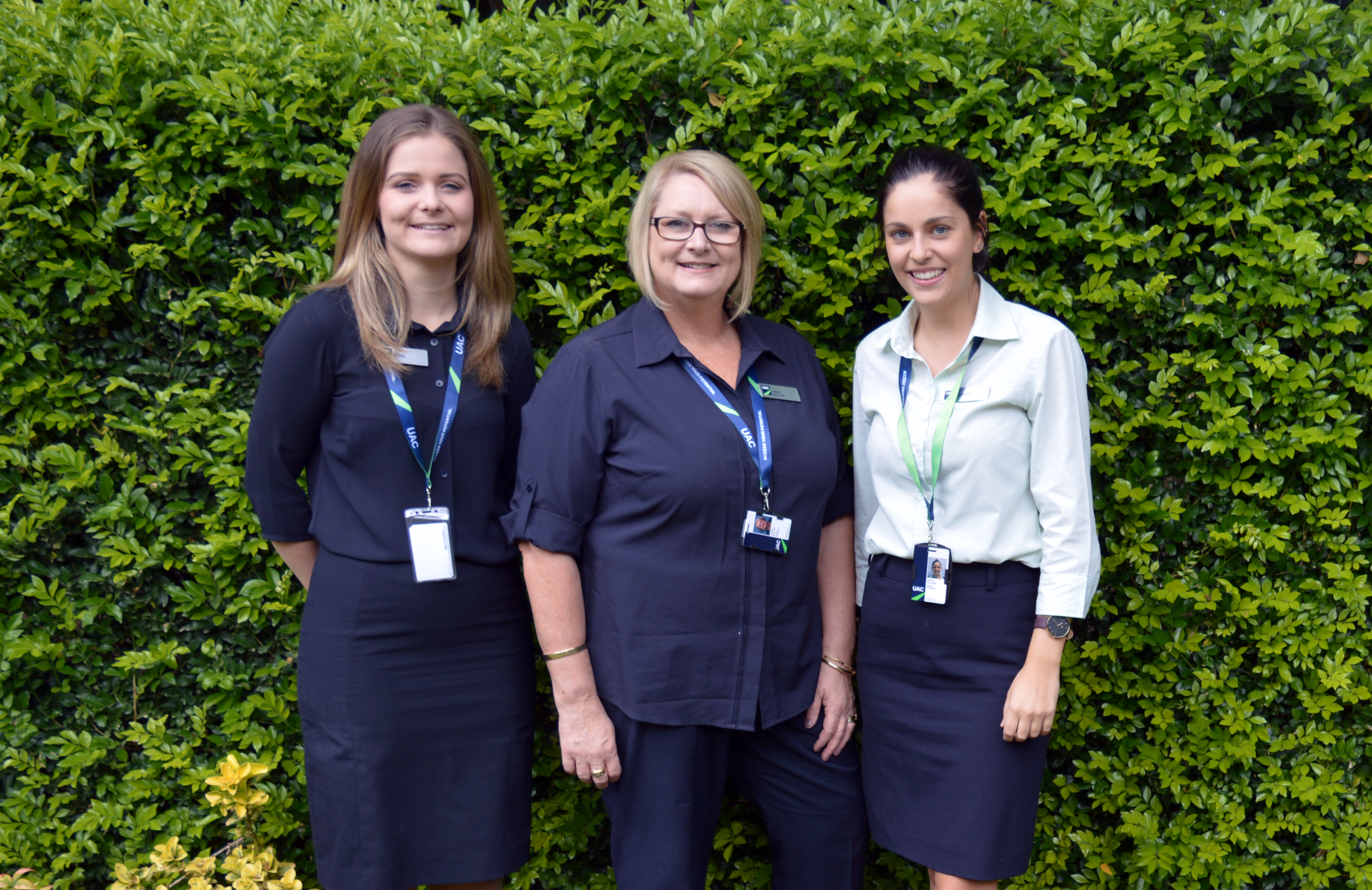 UAC's Community Engagement Team, Erin Keech, Trudy Noller and Kirsty Olliver standing together in front of wall of vines UAC's Community Engagement Team, Erin Keech, Trudy Noller and Kirsty Olliver standing together in front of wall of vines