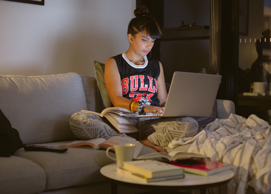 Woman sitting on couch using her computer