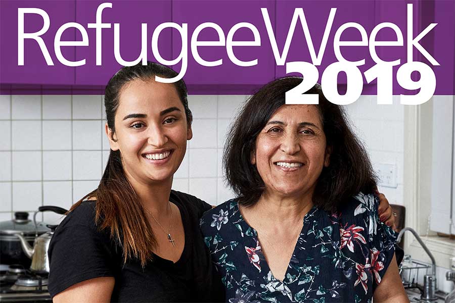 Refugee Week 2019 poster showing two women, possibly mother and daughter, in a kitchen smiling to camera Refugee Week 2019 poster showing two women, possibly mother and daughter, in a kitchen smiling to camera