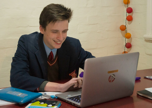 Year 10 student Edward Wilson completes homework using his laptop