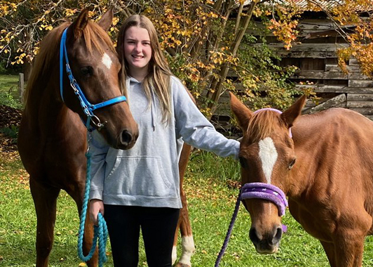 Year 10 student Mackensie Daley with her two horses