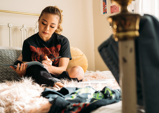 Girl studying on her bed
